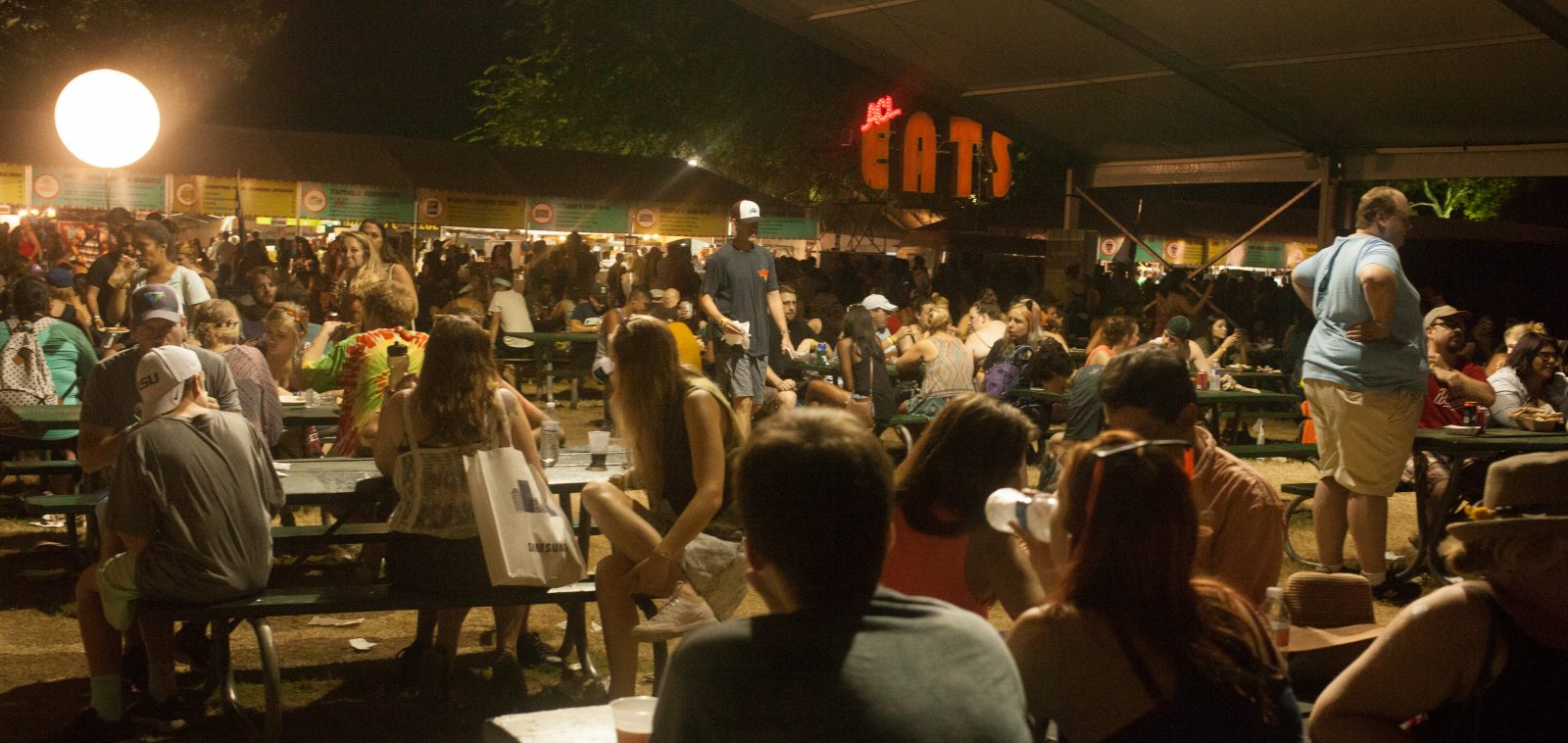 Festival crowd enjoying live music health benefits