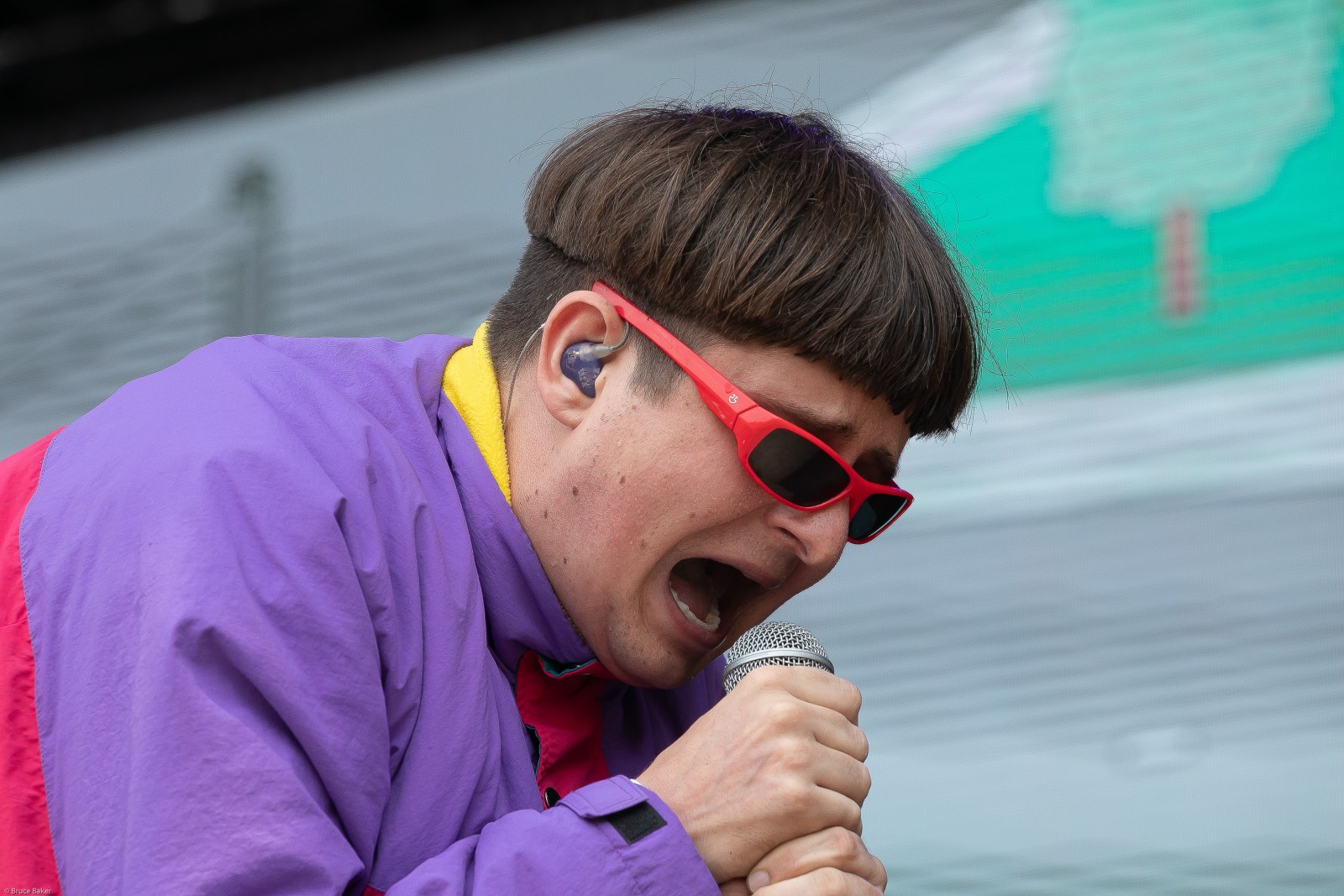 Oliver Tree singing into a microphone wearing his signature sunglasses