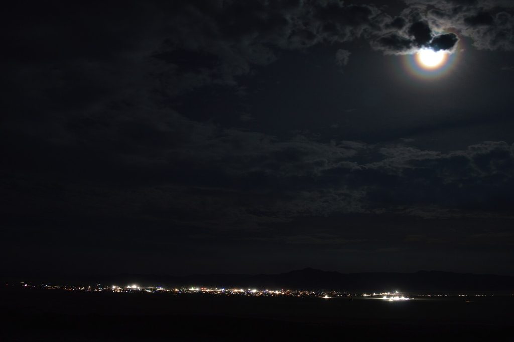 Black Rock City illuminated at night during Burning Man in Nevada