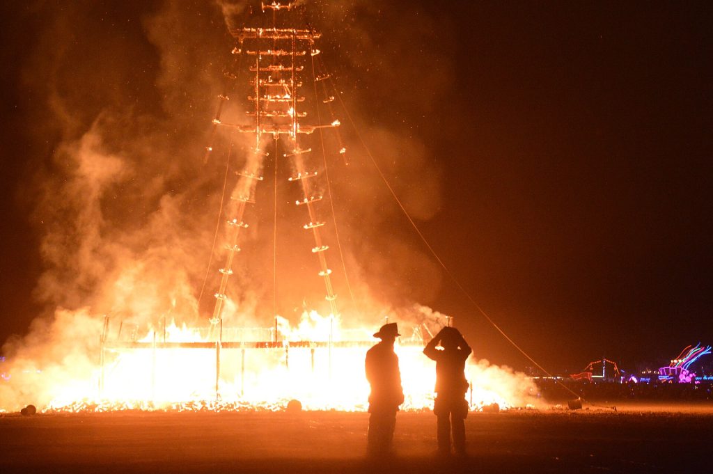 The Man effigy burning at night at Burning Man in the Black Rock Desert, Nevada