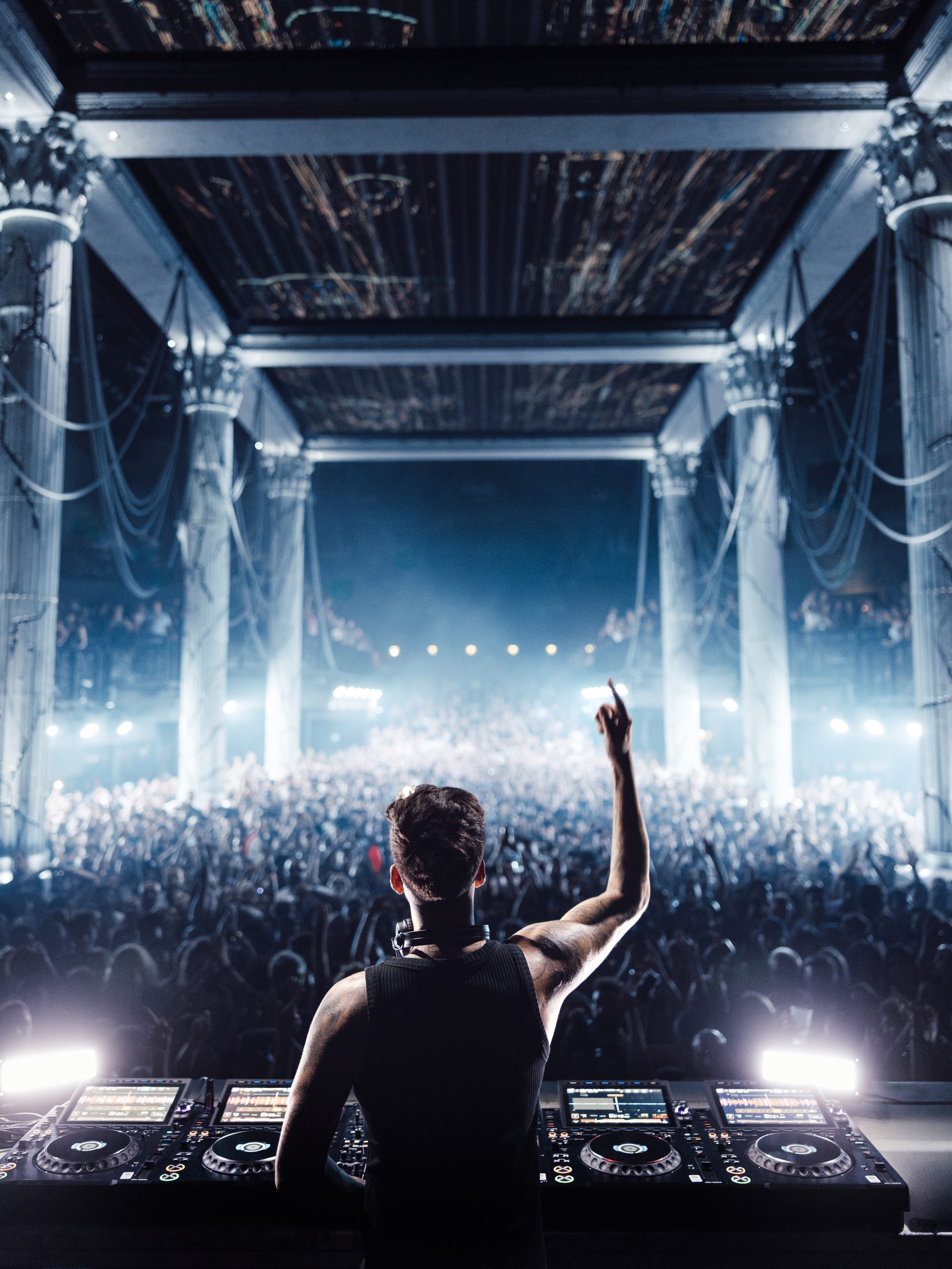Anyma performing to a packed [UNVRS] main room framed by marble columns