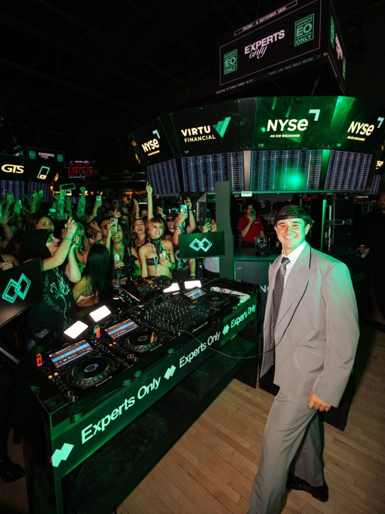 John Summit in a suit behind the Experts Only DJ booth at the NYSE