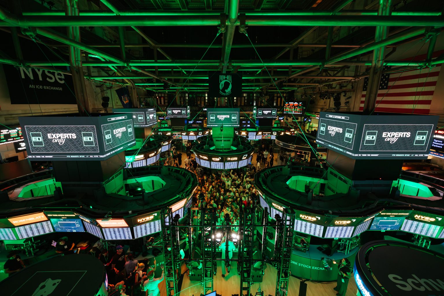 John Summit NYSE takeover: the New York Stock Exchange trading floor lit green with Experts Only screens