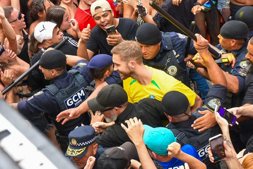 Calvin Harris escorted by the municipal guard through the crowd at his record breaking Sao Paulo set