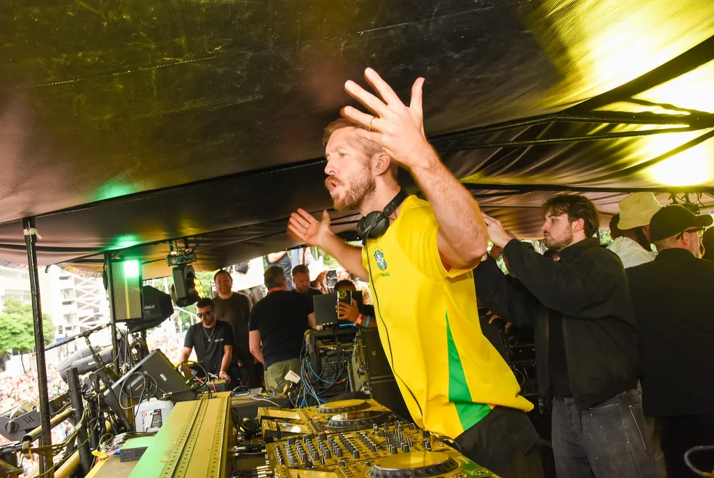 Calvin Harris raising his hands during the Guinness World Record DJ set in Sao Paulo