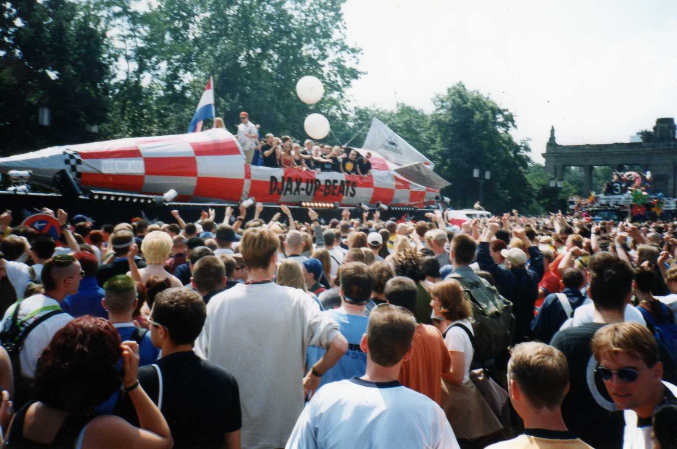 Love Parade 1998 float moving through the crowd in Berlin Tiergarten