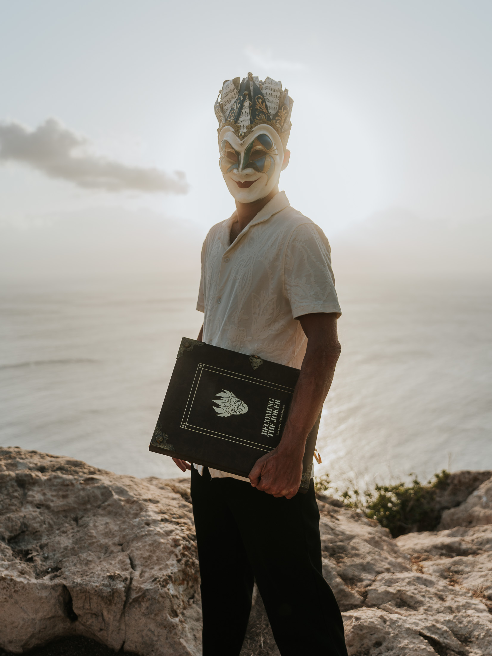 Boris Brejcha retirement announcement press photo of The Joker holding the Becoming the Joker book
