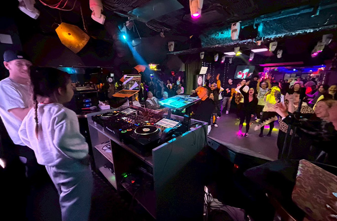 DJ ILLU, the youngest female club DJ, playing in the booth at a Yokohama club
