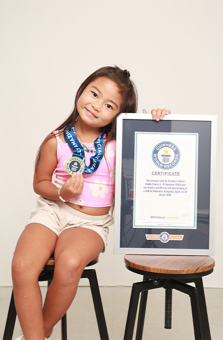 DJ ILLU posing with her Guinness World Records certificate for youngest club DJ (female)