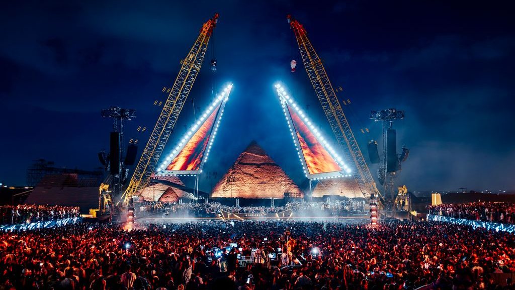 Starlight Festival Giza main stage framed by the Pyramids of Giza at dusk